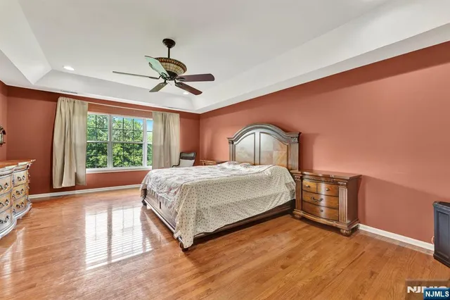 a bedroom with a bed dresser and a window