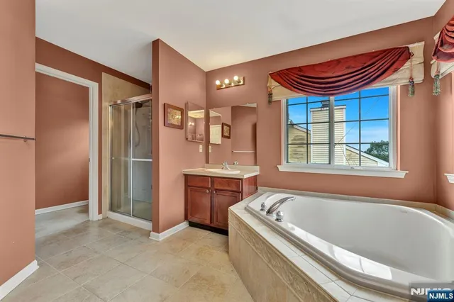 a bathroom with a bathtub and a shower