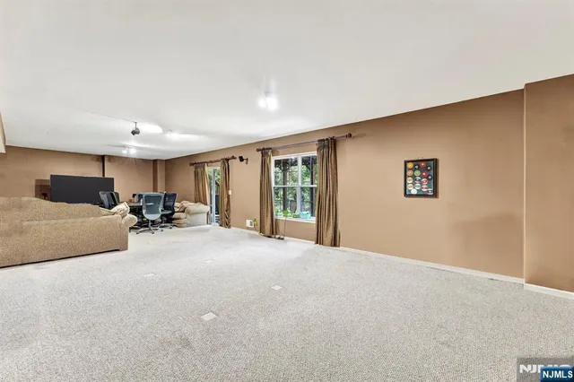 a large bedroom with bed and a large window