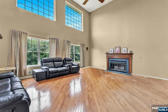 a living room with furniture a fireplace and a large window