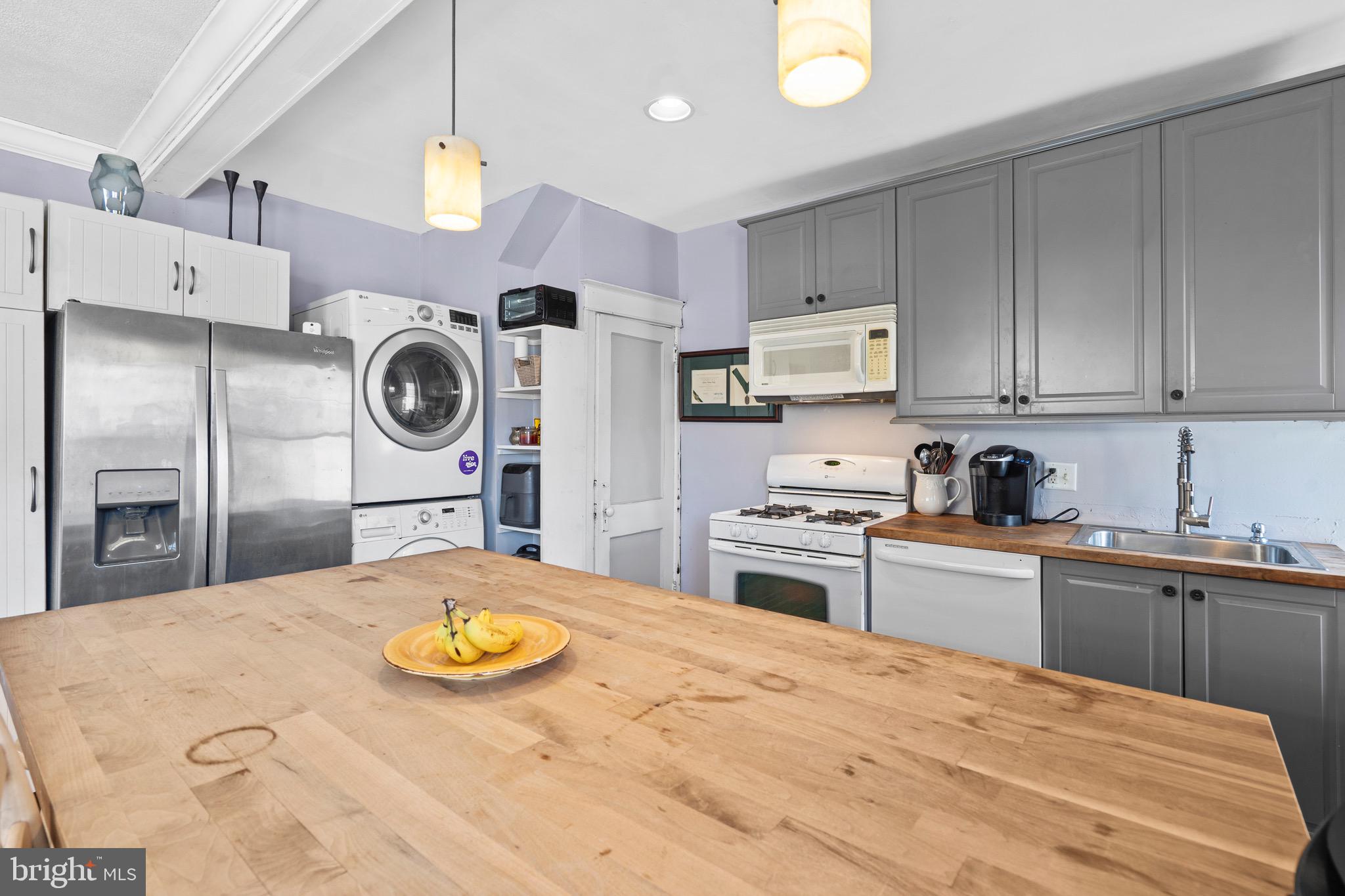122 Wilson Avenue Havertown, PA 19083 - Photo 12 of 30 a kitchen with kitchen island a stove a sink and a refrigerator
