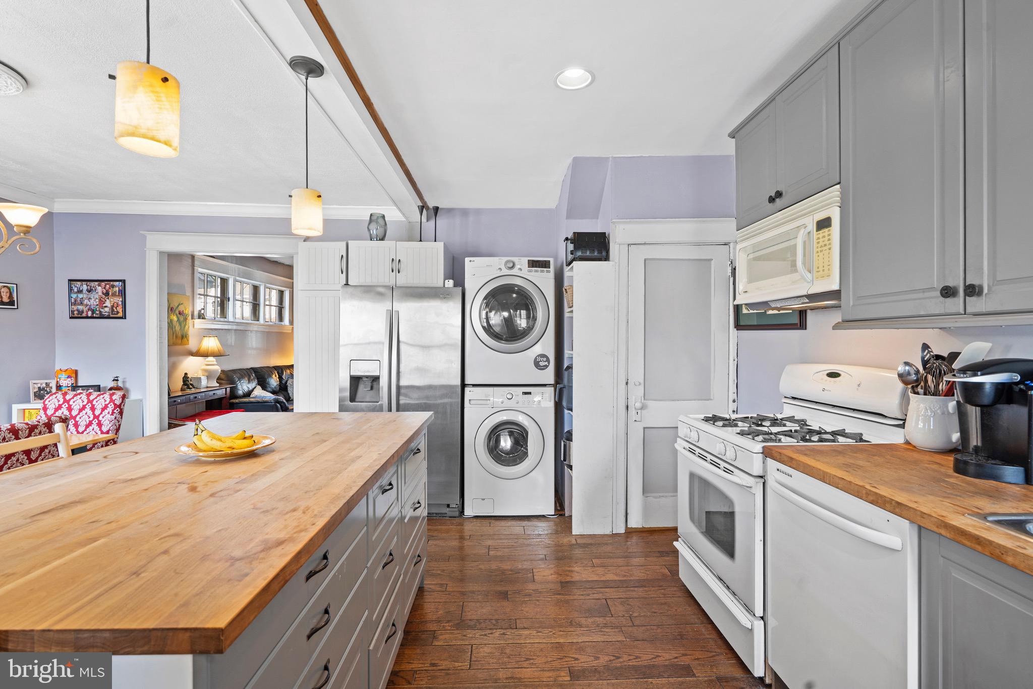 122 Wilson Avenue Havertown, PA 19083 - Photo 13 of 30 a kitchen with stainless steel appliances granite countertop a stove a sink dishwasher and white cabinets with wooden floor