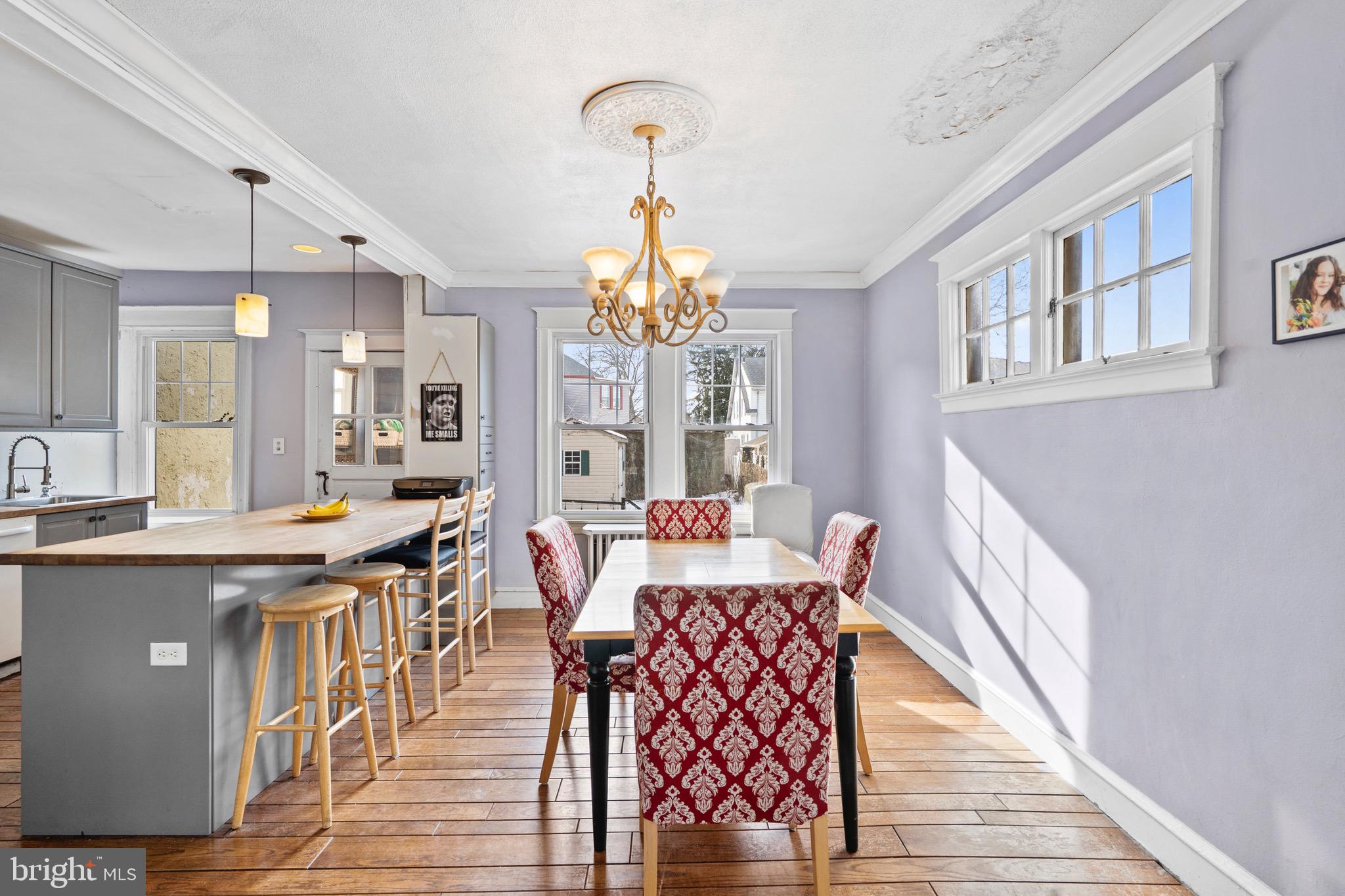 122 Wilson Avenue Havertown, PA 19083 - Photo 8 of 30 a very nice looking dining room with kitchen island stainless steel appliances a table and a chandelier