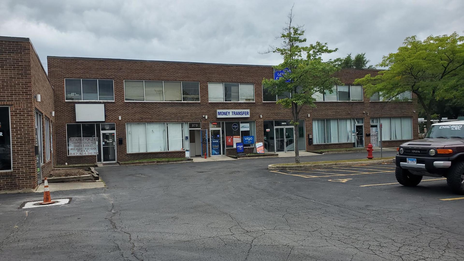 983 West Wise Road, Unit 983 Schaumburg, IL 60193 - Photo 4 of 13 a view of a car park in front of building