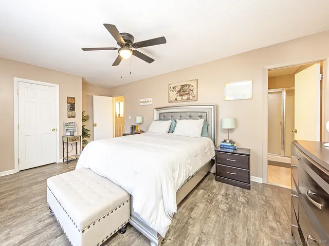 a bathroom with a sink a mirror a toilet and a shower