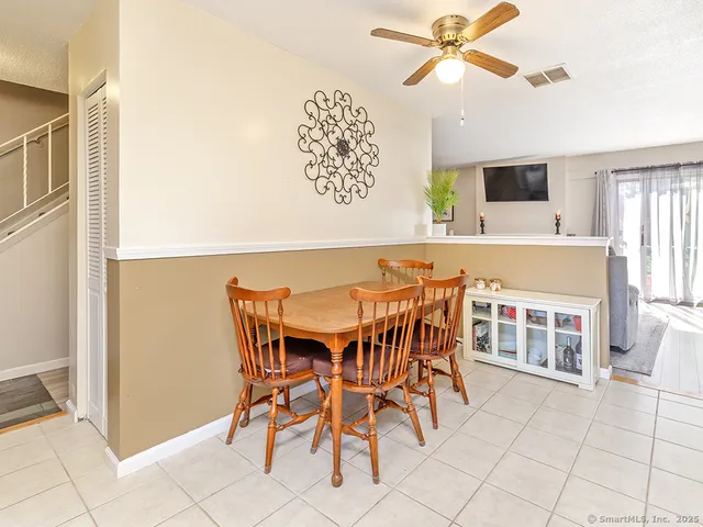 a view of a dining room with furniture and window