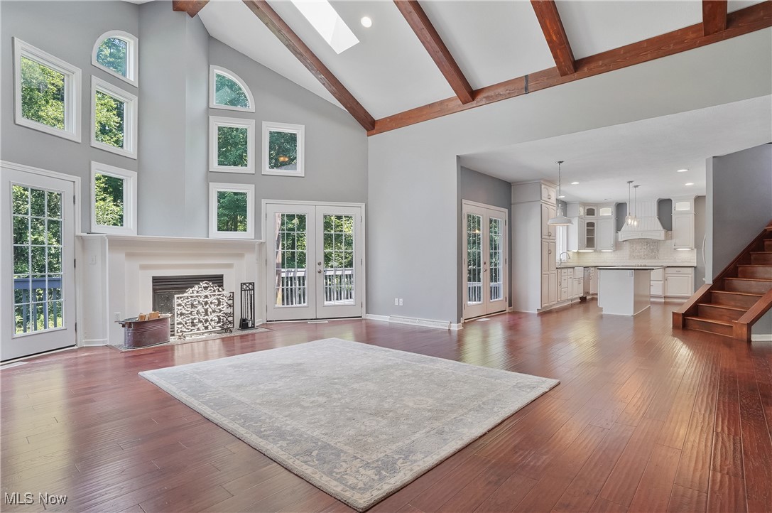 1453 Prospect Road Hudson, OH 44236 - Photo 15 of 50 Living room with high vaulted ceiling, a fireplace with flush hearth, beamed ceiling, a skylight, and recessed lighting