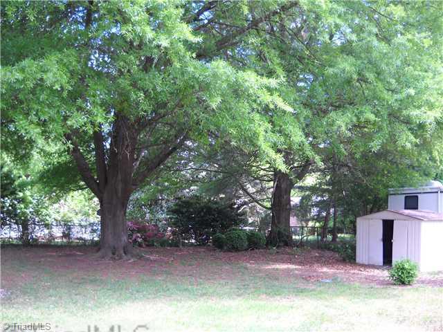 3218 Pine Needles Road High Point, NC 27265 - Photo 11 of 12 Yard/Garden. Huge oak tree shades this large fenced back yard in summer. Storage building will remain.