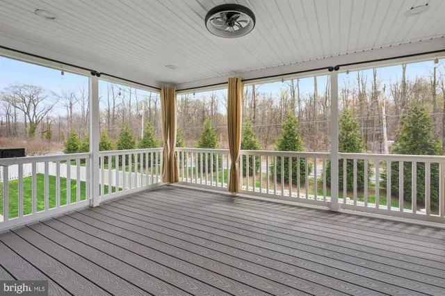 a view of backyard with deck and wooden floor