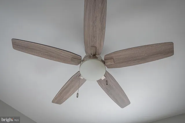 a bathroom with a granite countertop bathtub shower and toilet