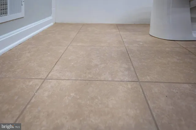 an empty room with ceiling fan and window