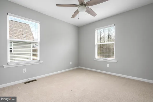 a view of an house with backyard and porch