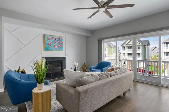 a living room with furniture a fireplace and a potted plant