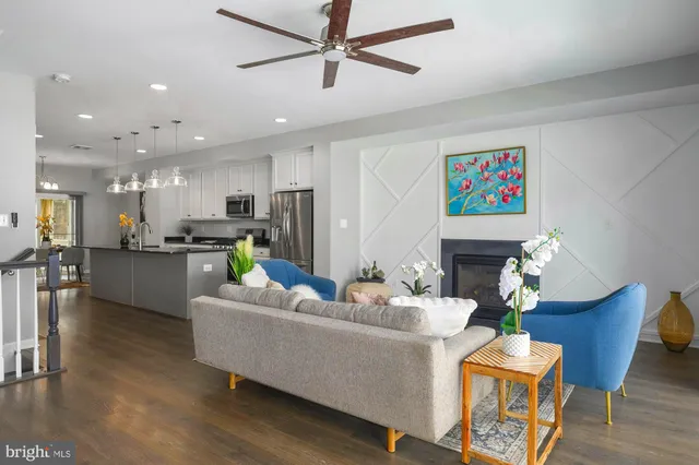 a living room with fireplace furniture and a wooden floor
