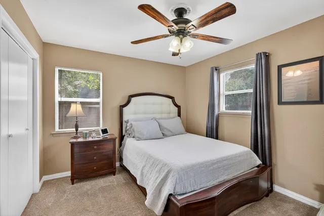 a bedroom with a large bed and a window