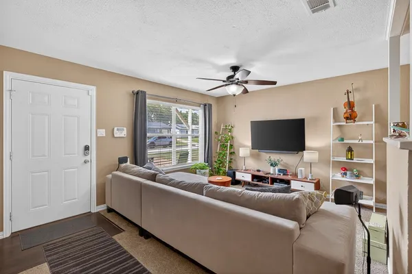 a living room with furniture and a flat screen tv