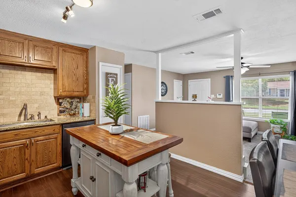 a kitchen with sink cabinets and wooden floor