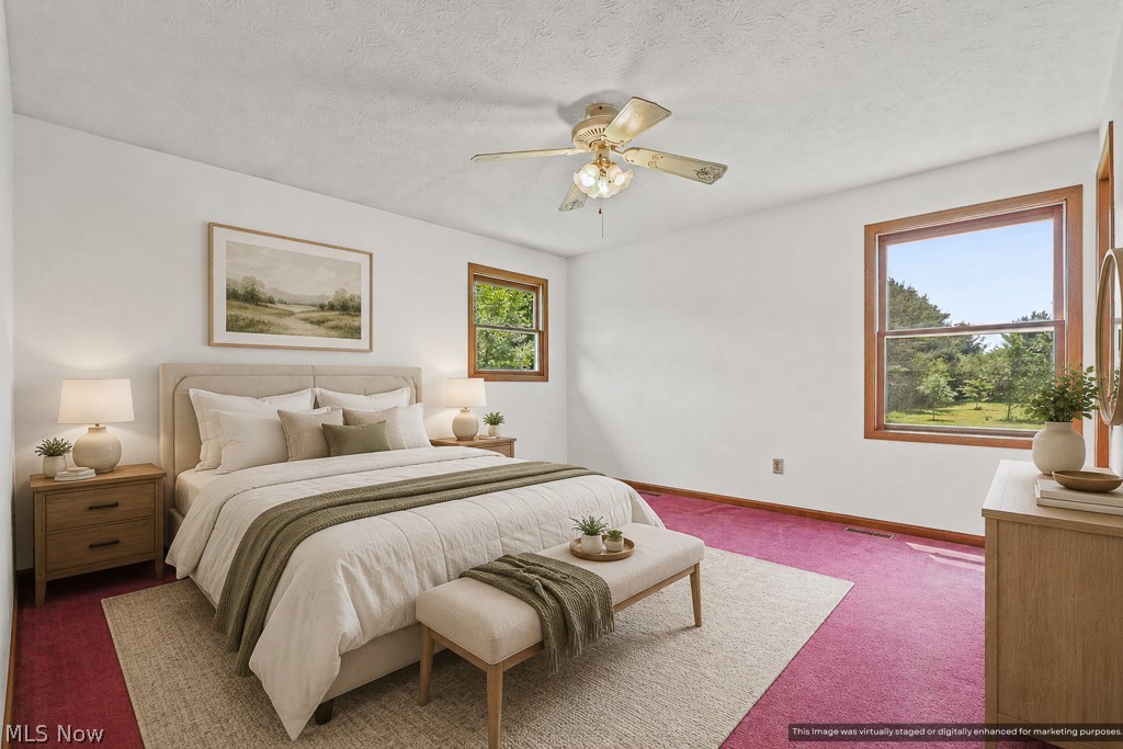 2642 Blake Road Wadsworth, OH 44281 - Photo 17 of 46 Bedroom featuring a generously sized window with wood trim, a ceiling fan, and a neutral wall color