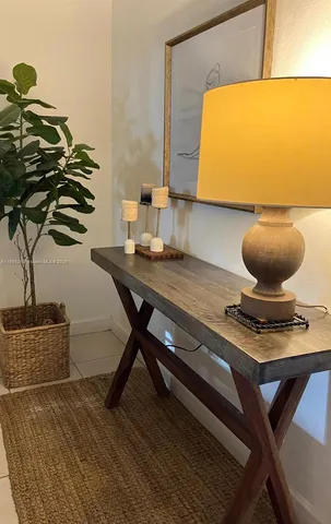 a living room with a table and a potted plant