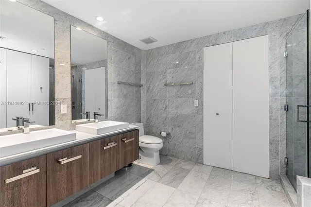a spacious bathroom with a double vanity sink mirror and double