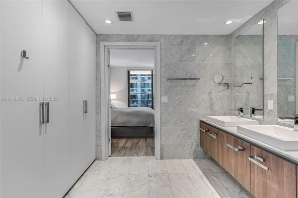 a spacious bathroom with a granite countertop sink a toilet and shower