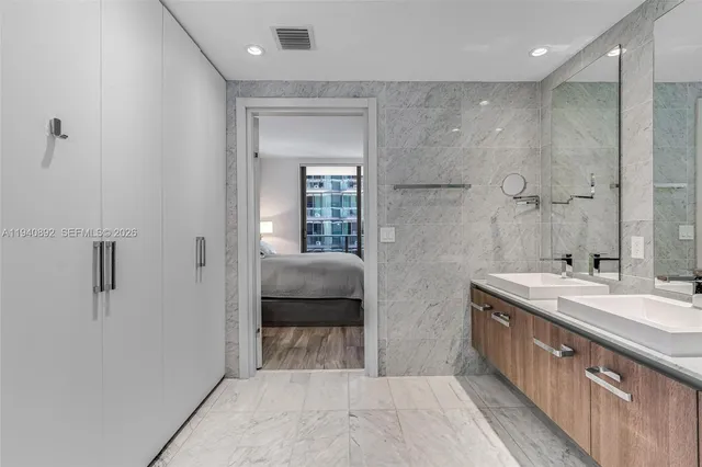 a spacious bathroom with a granite countertop sink a toilet and shower