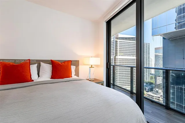 a bedroom with a large bed and a large window