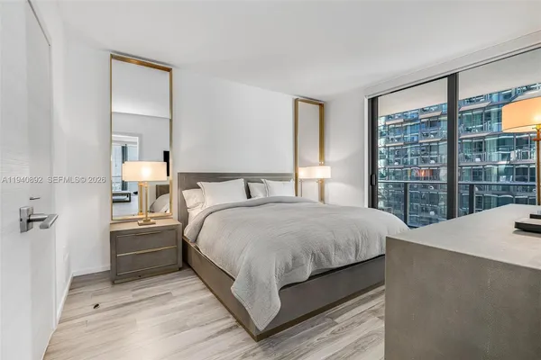 a bedroom with a large bed and a large window