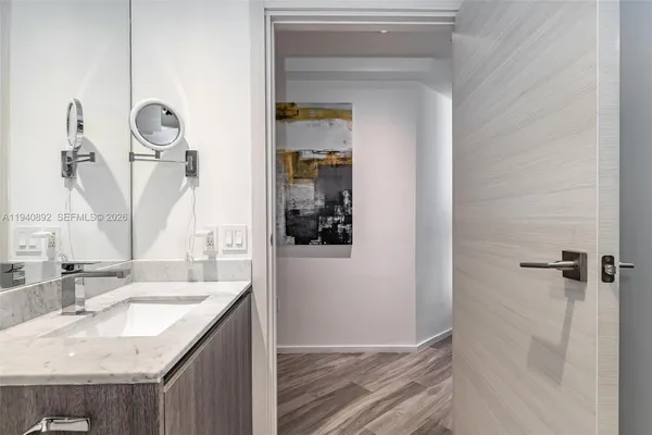 a bathroom with a granite countertop sink and a mirror