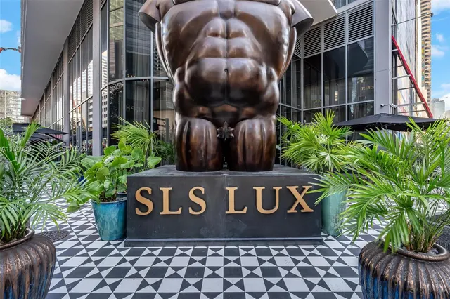 a view of a sign board with potted plants