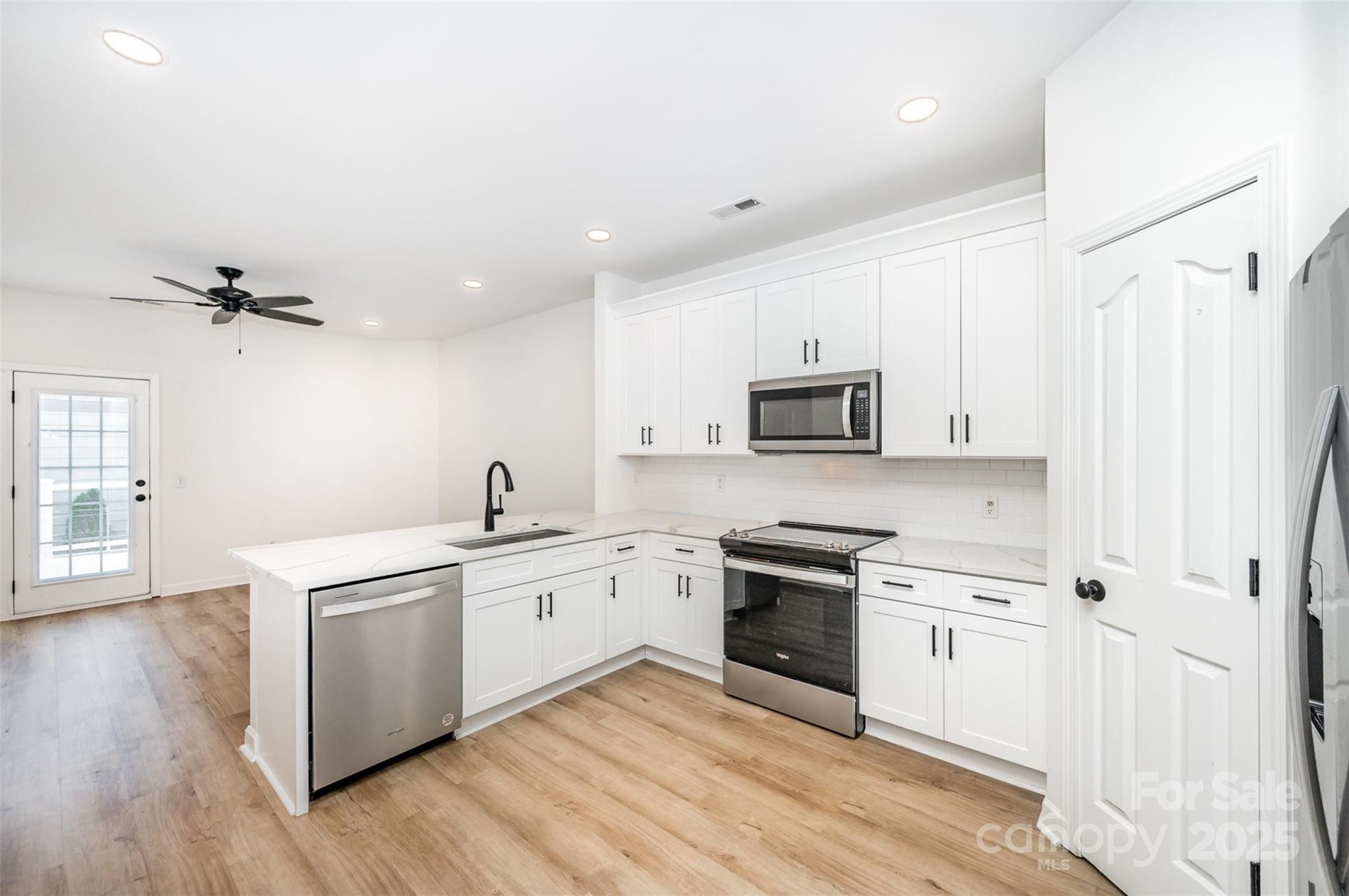 1135 Market Street Fort Mill, SC 29708 - Photo 10 of 36 a kitchen with a sink cabinets and wooden floor