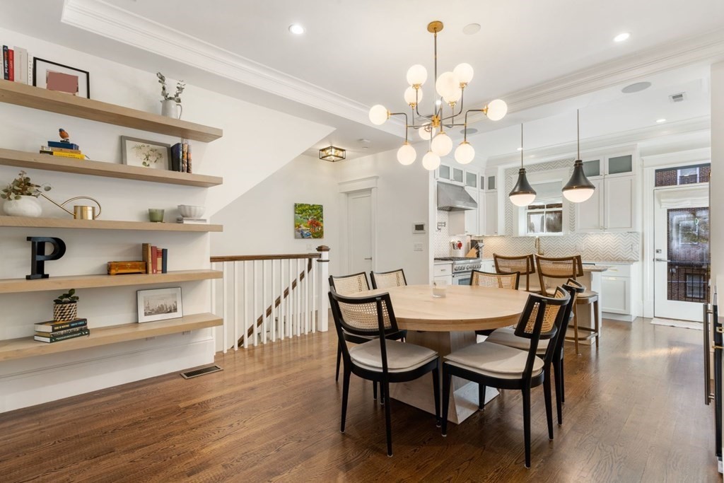 a view of a dining room with furniture and wooden floor