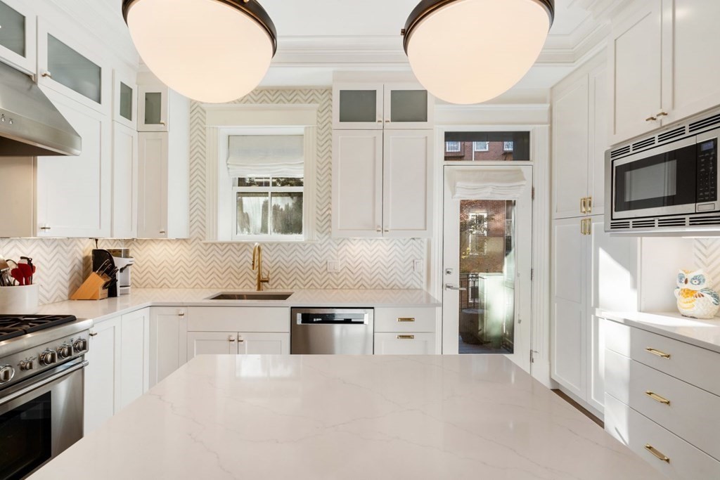 34 Dwight Street, Unit 1 Boston, MA 02118 - Photo 11 of 40 a kitchen with stainless steel appliances a refrigerator a stove a microwave and cabinets
