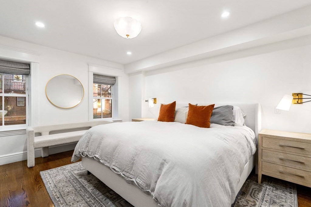 34 Dwight Street, Unit 1 Boston, MA 02118 - Photo 20 of 40 a bedroom with a bed a mirror and a window