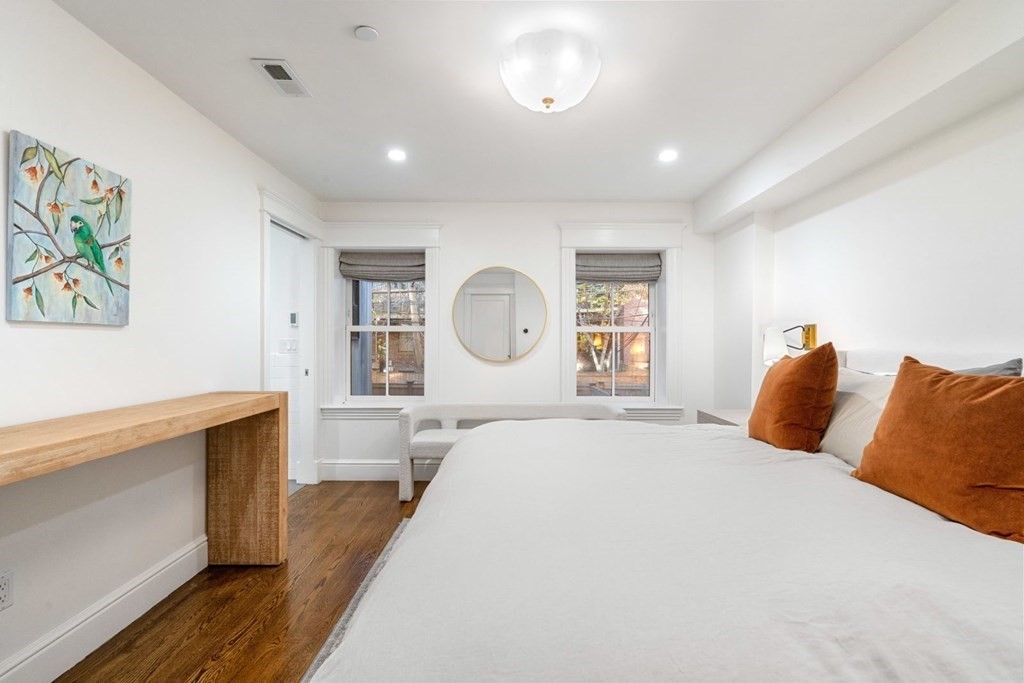 34 Dwight Street, Unit 1 Boston, MA 02118 - Photo 21 of 40 a bedroom with a large bed and a chandelier