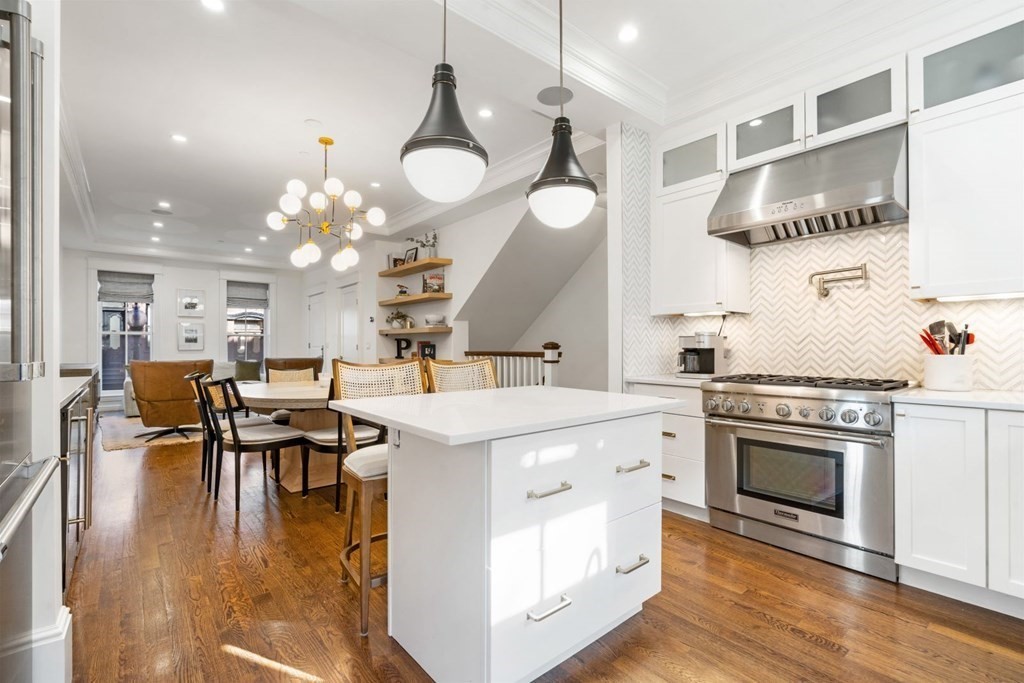 34 Dwight Street, Unit 1 Boston, MA 02118 - Photo 7 of 40 a kitchen with a stove cabinets and wooden floor