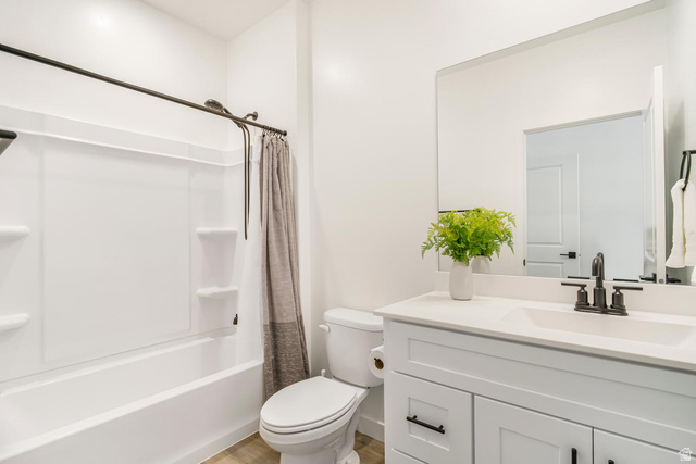 1705 Ripple Rock Drive, Unit 3017 Washington, UT 84780 - Photo 14 of 22 Contemporary bathroom featuring a white vanity with shaker-style cabinetry, a solid surface countertop, an undermount sink, and matte black fixtures