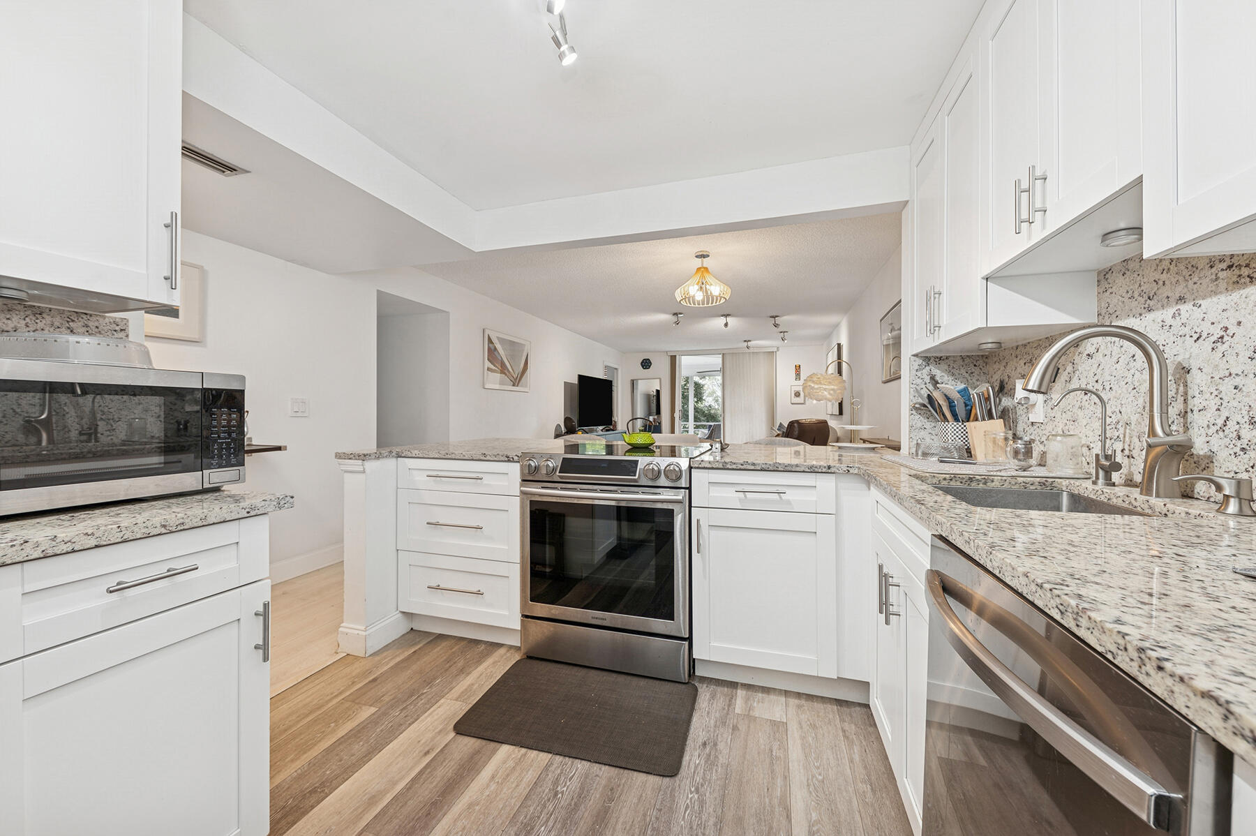 5961 Northwest 2nd Avenue, Unit 304 Boca Raton, FL 33487 - Photo 3 of 15 a kitchen with granite countertop a sink stainless steel appliances and cabinets