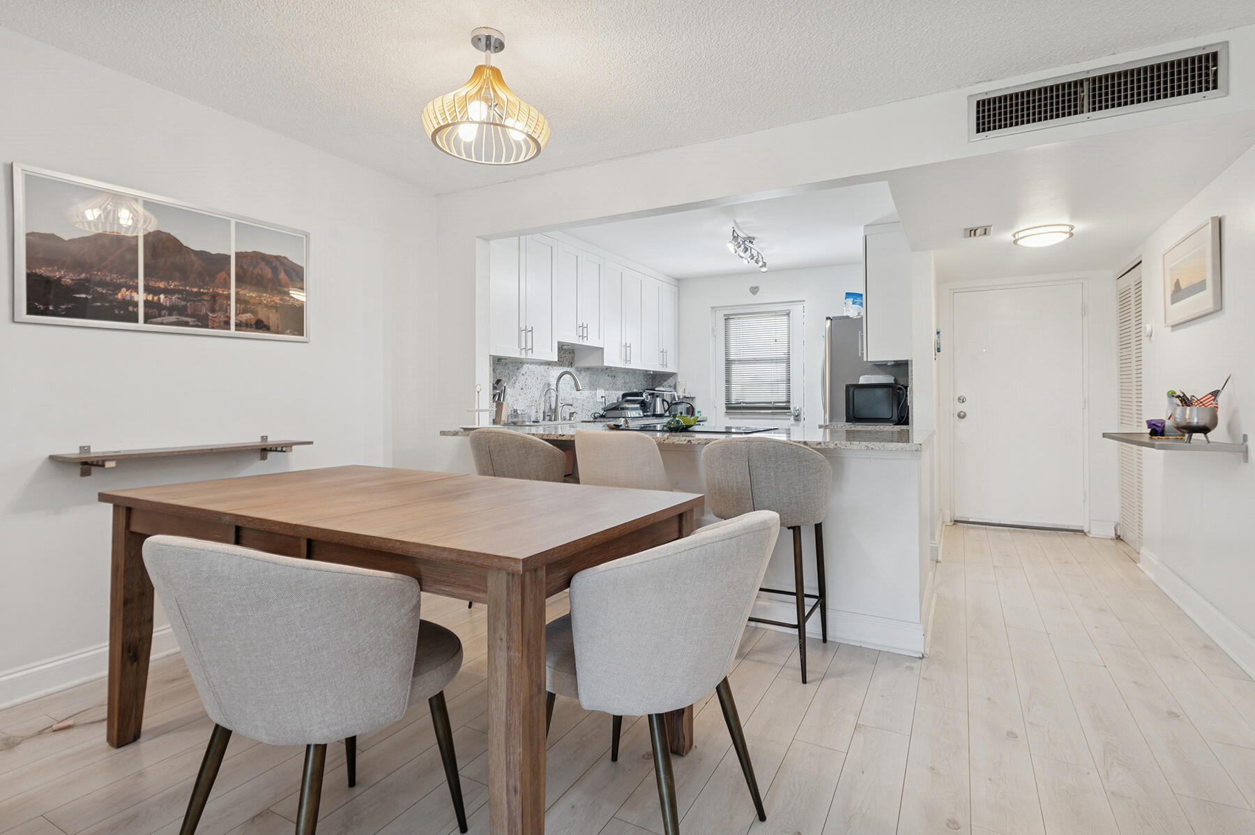 5961 Northwest 2nd Avenue, Unit 304 Boca Raton, FL 33487 - Photo 5 of 15 a view of a dining room with furniture and wooden floor