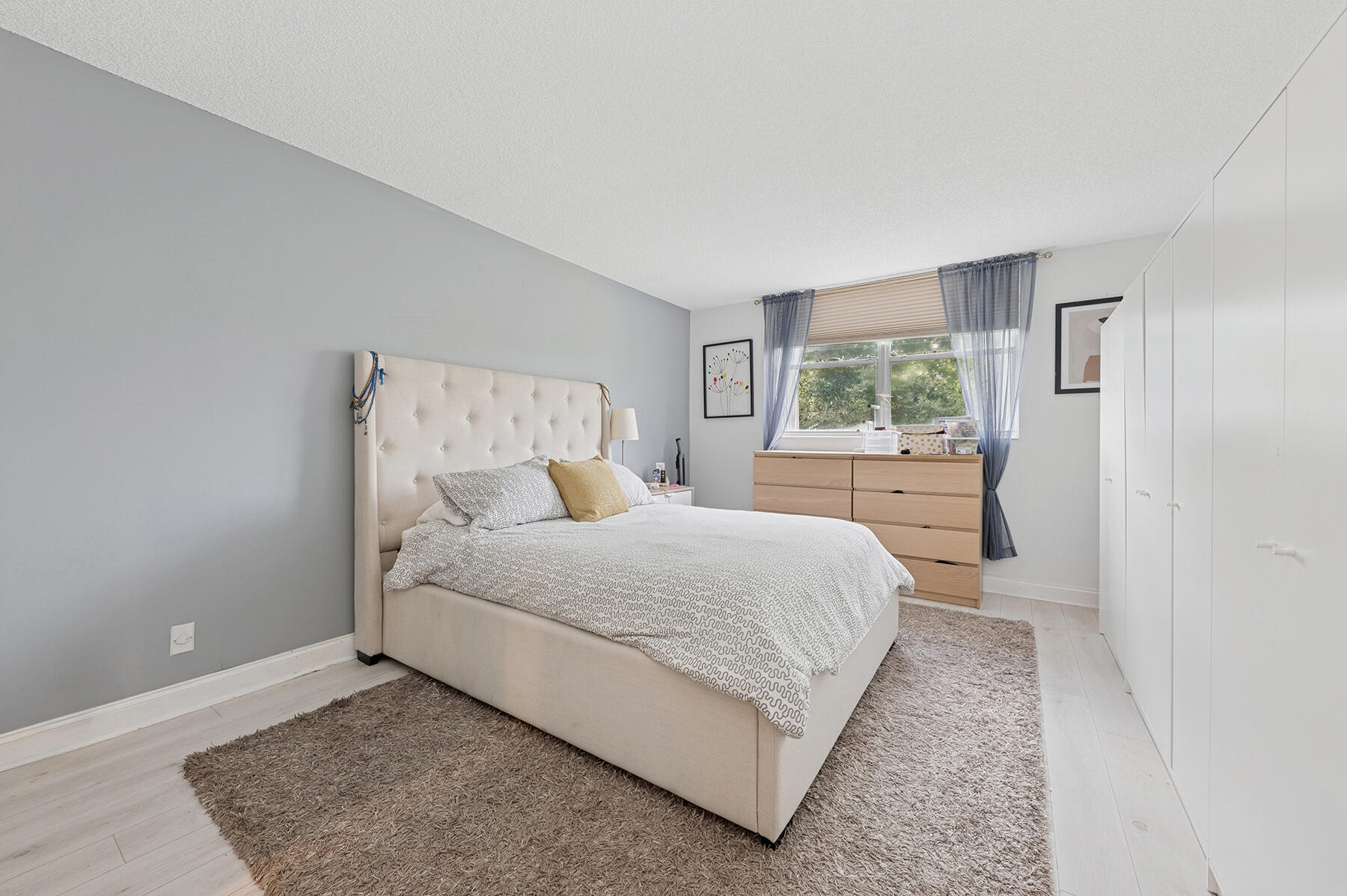 5961 Northwest 2nd Avenue, Unit 304 Boca Raton, FL 33487 - Photo 10 of 15 a bedroom with a bed and window