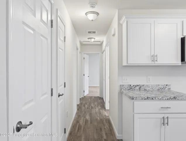 a bathroom with a toilet sink a mirror and vanity