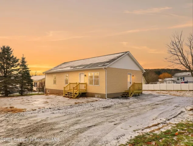 a picture of a room with a white wall and a refrigerator