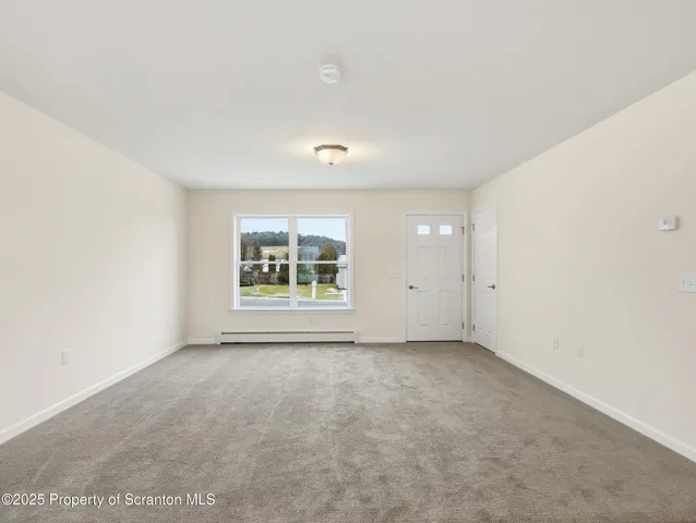 a view of a kitchen with wooden floor and electronic appliances