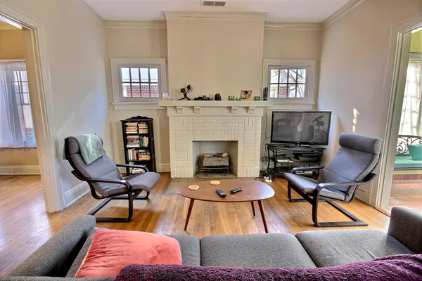 a living room with furniture and a fireplace