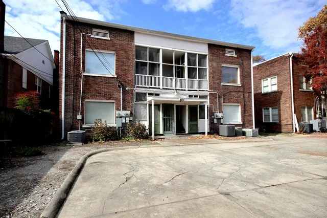 a front view of a building with a garden