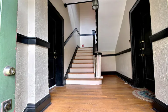 a view of entryway and hall with wooden floor