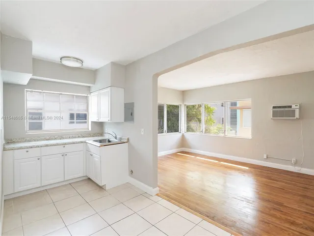 a spacious bathroom with a granite countertop sink a mirror and a shower