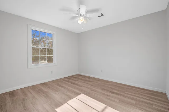 wooden floor in an empty room with a window