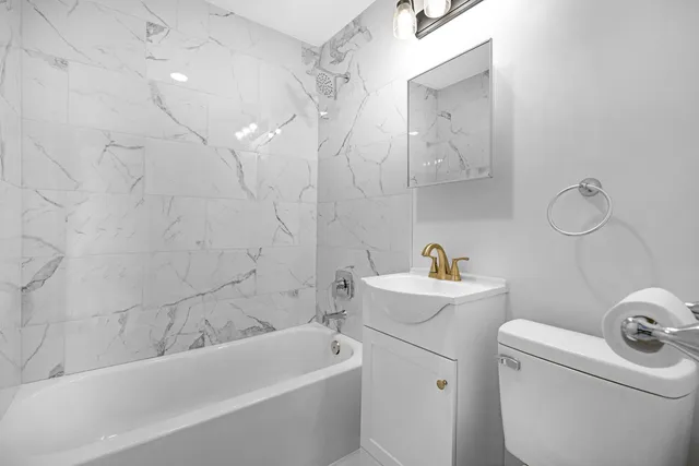 an empty room with a window and wooden floor