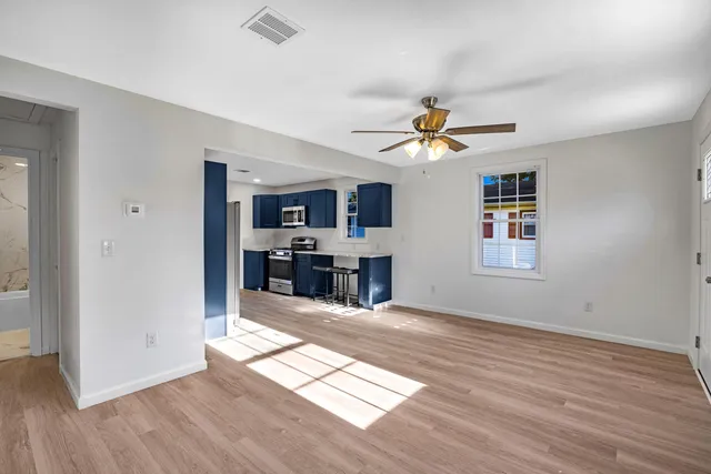 a kitchen with stainless steel appliances granite countertop a refrigerator a stove top oven a sink dishwasher and wooden cabinets